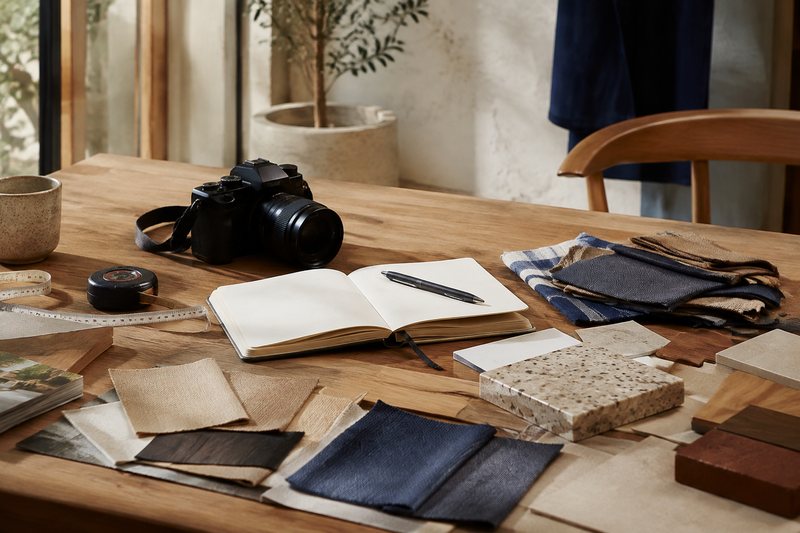 An editor reviewing home-product samples, notes and measurements